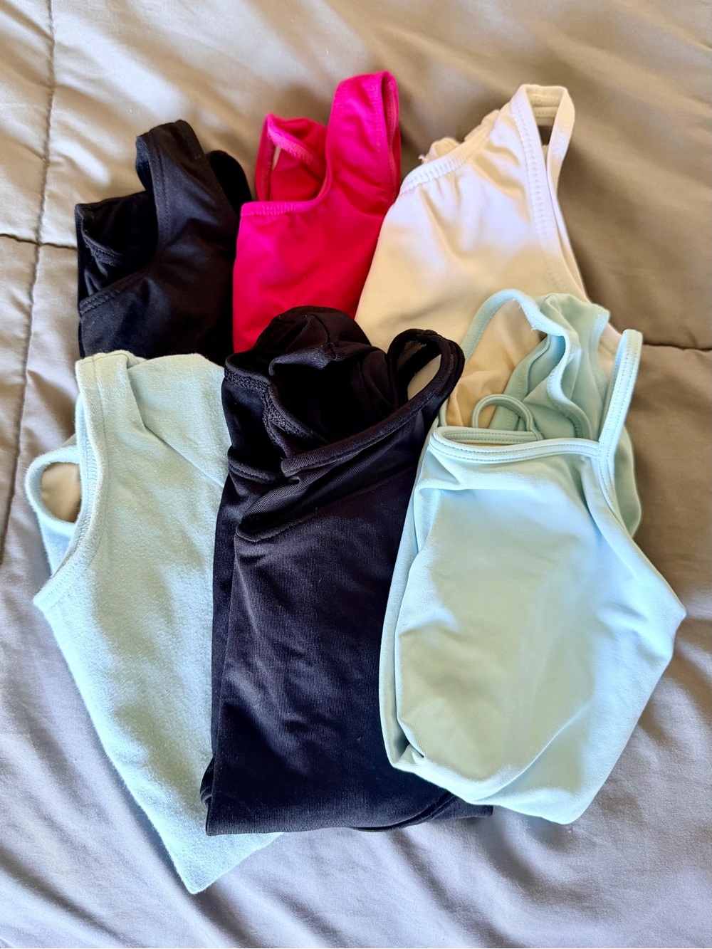 Capezio Kids One-Piece Leotards in Black, Hot Pink, White, and Light Blue
